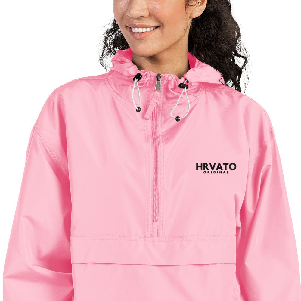 Close-up of HRVATO embroidery on a pink packable jacket